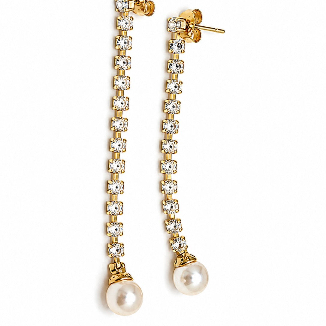 Gold and pearl earrings on a white background