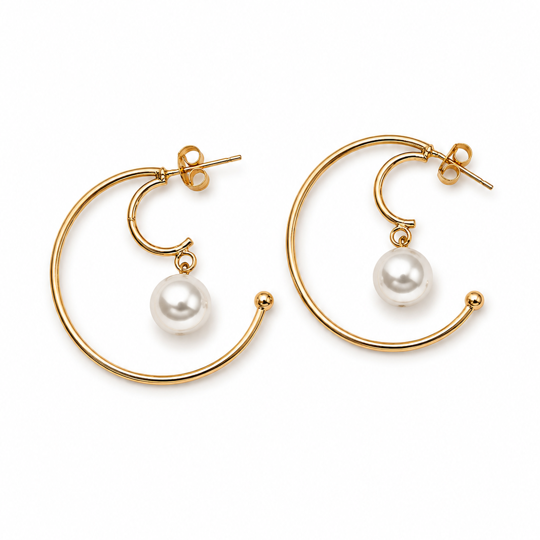 Gold hoop earrings with pearl drops on a white background