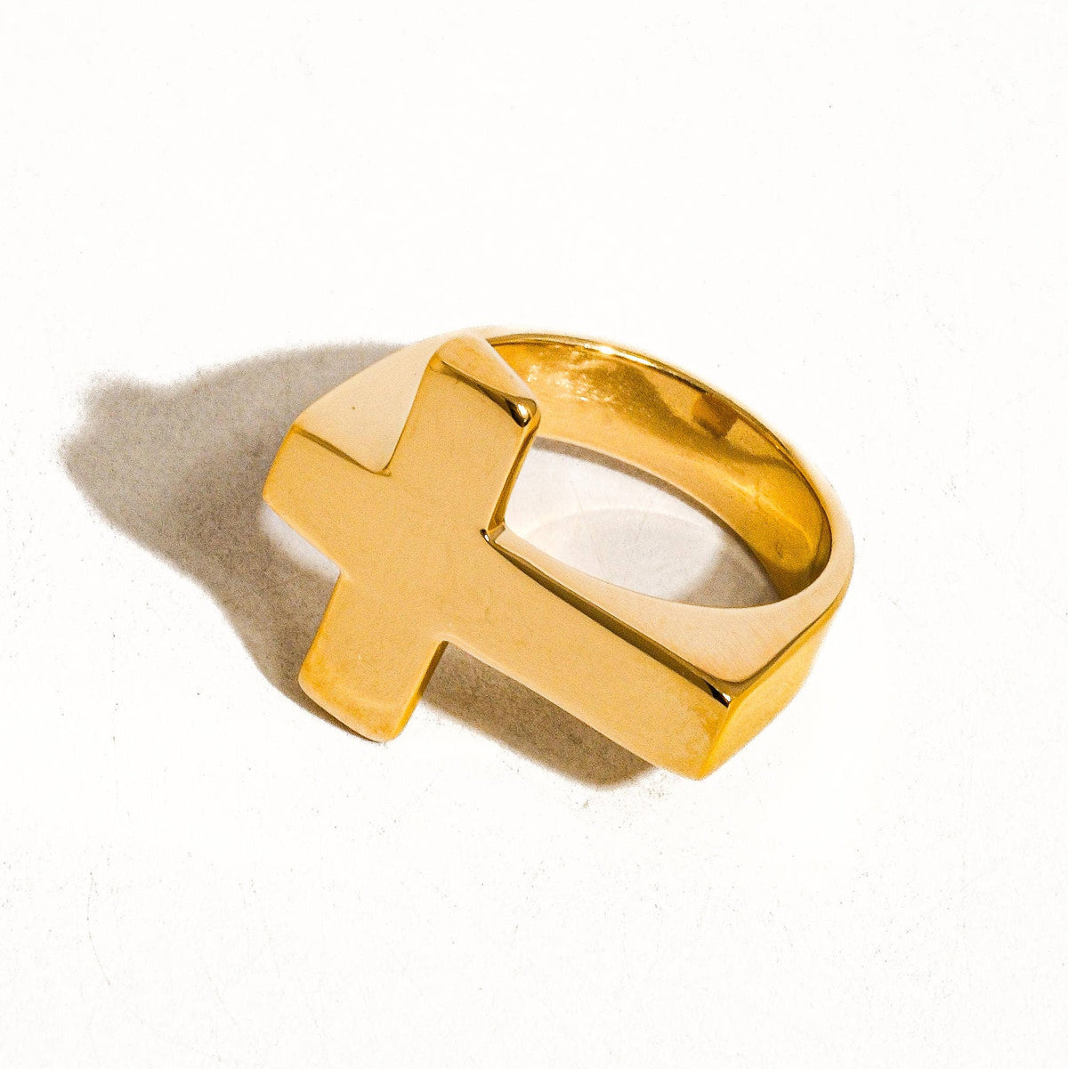 Gold ring with a unique design on a white background