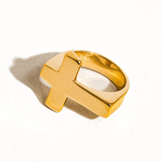 Gold ring with a unique design on a white background