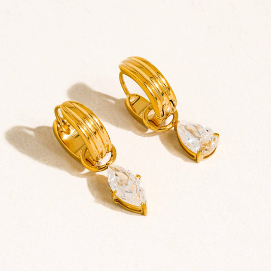 Gold hoop earrings with clear gemstones on a white background